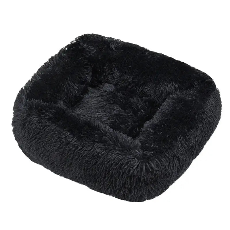 Fluffy black pet bed with raised edges and a soft, plush texture.