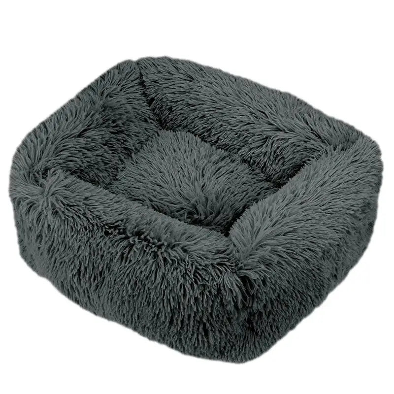 Fluffy, dark gray pet bed with raised sides and a plush, cushioned interior.