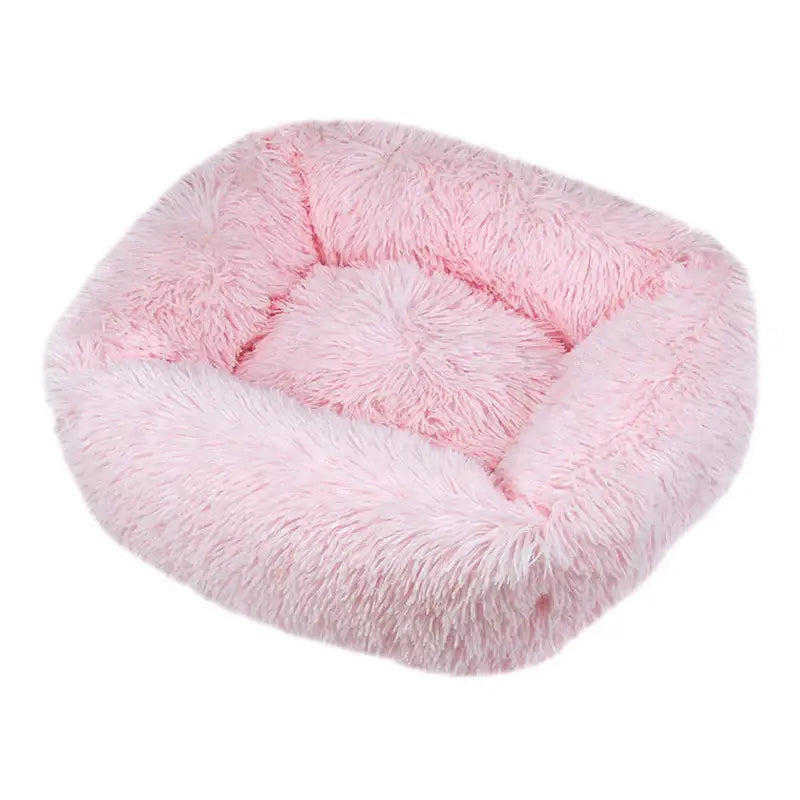 Fluffy pink pet bed with raised edges and a plush interior.