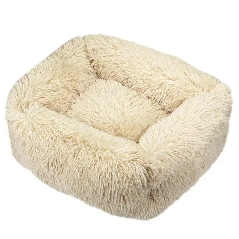 Fluffy, square-shaped pet bed with long, shaggy beige fur.