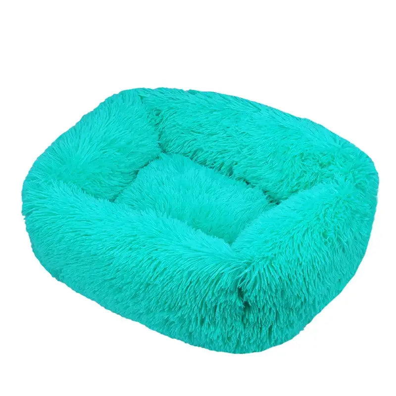 Fluffy teal pet bed with raised sides and a cushioned interior.