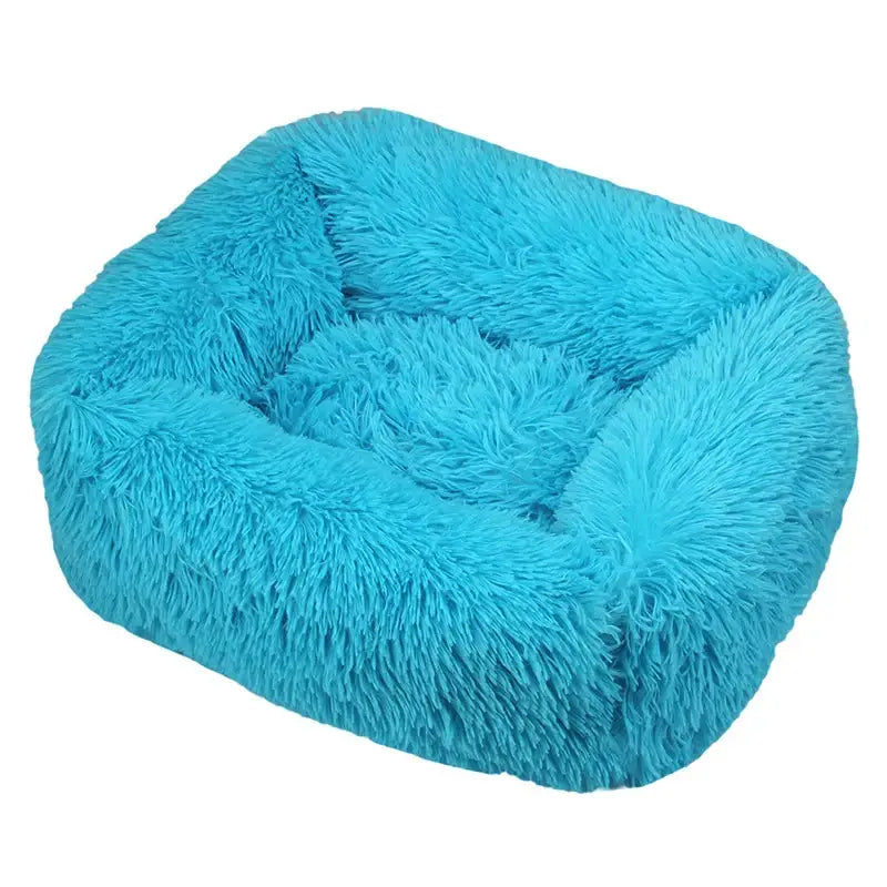 Fluffy turquoise pet bed with raised sides.