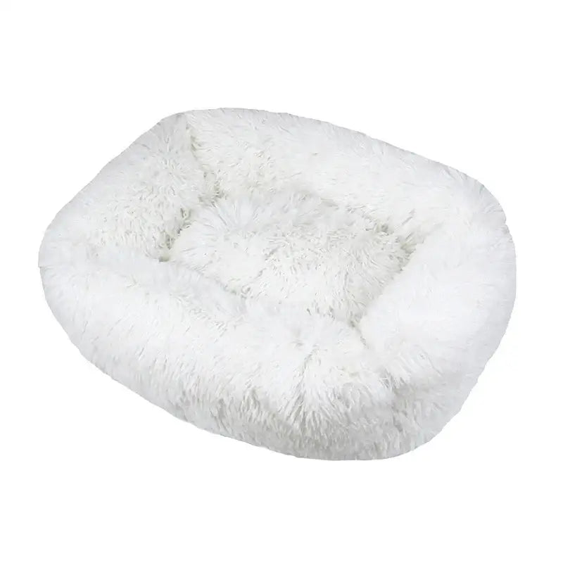 Fluffy white oval pet bed with raised edges.