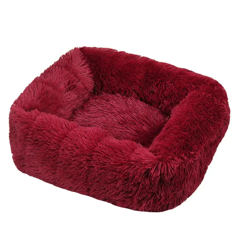 Plush, deep red pet bed with fluffy, fur-like texture.