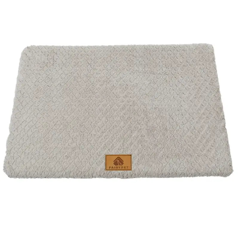 Plush off-white rectangular pet mat with a leather brand tag.