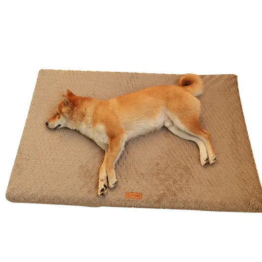 Shiba Inu dog lying stretched out on a beige cushion or mat.