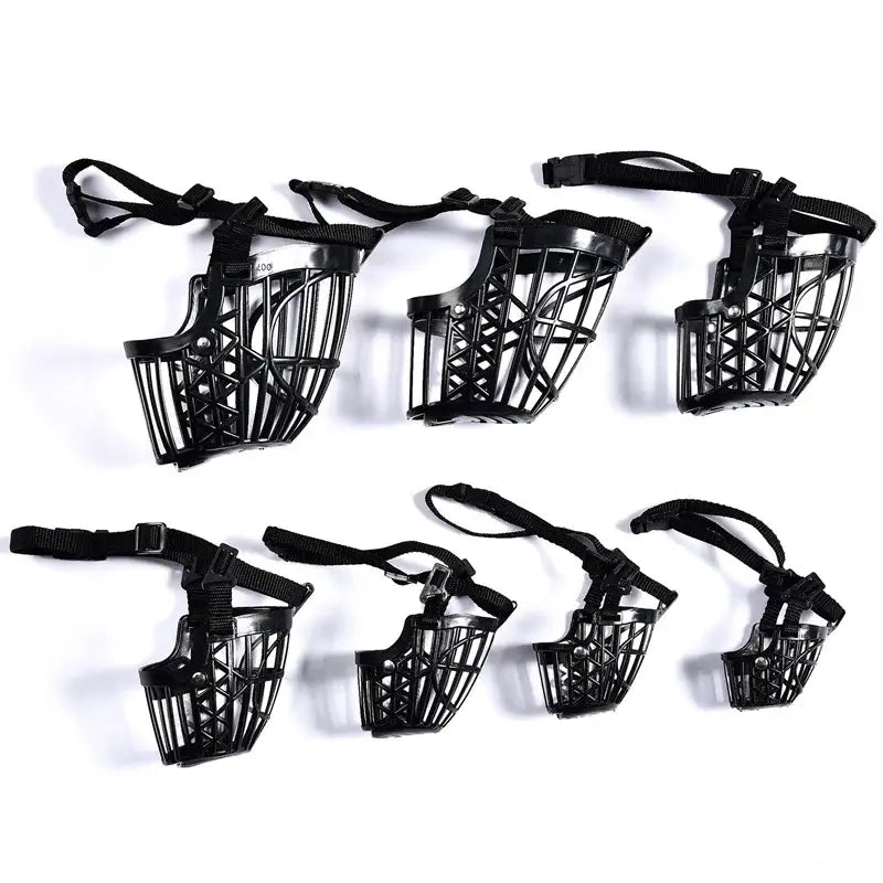 Set of black plastic dog muzzles in various sizes.