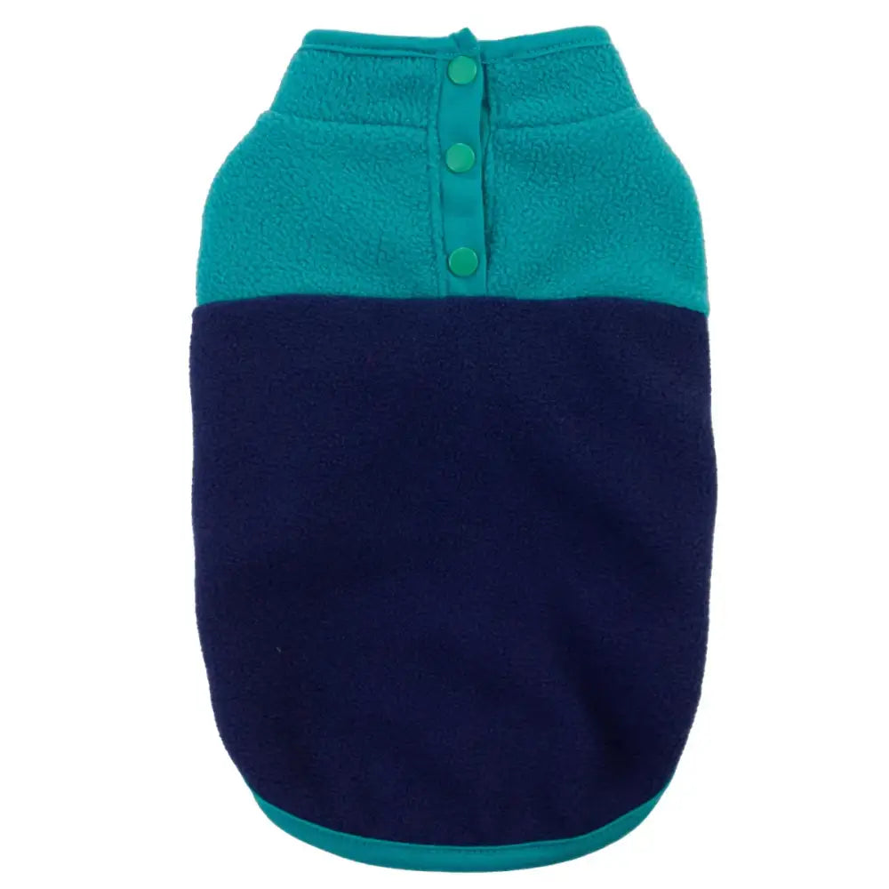 Two-toned dog sweater with teal top and navy bottom, featuring green buttons.