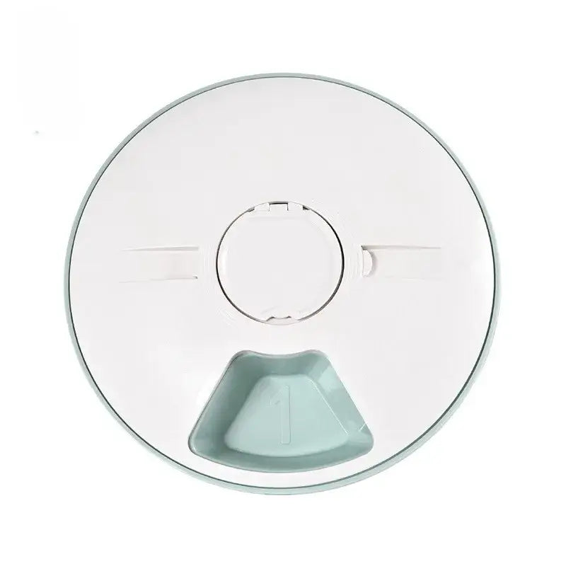 Circular white plastic lid with a small pale blue triangular compartment visible through a central opening.