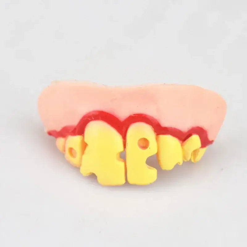 Plastic toy teeth with yellow blocks spelling ’HAPPY’ on the front.