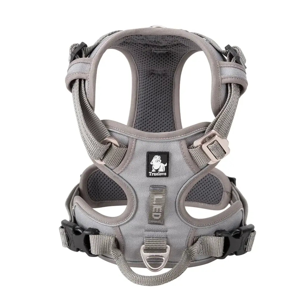 Gray and black padded dog harness with adjustable straps and buckles.