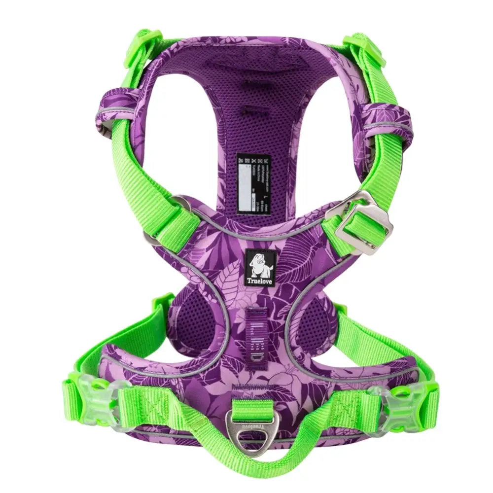 Purple and green dog harness with adjustable straps and mesh panels.