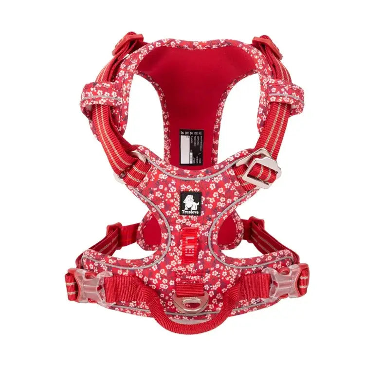 Red dog harness with white floral pattern and adjustable straps.