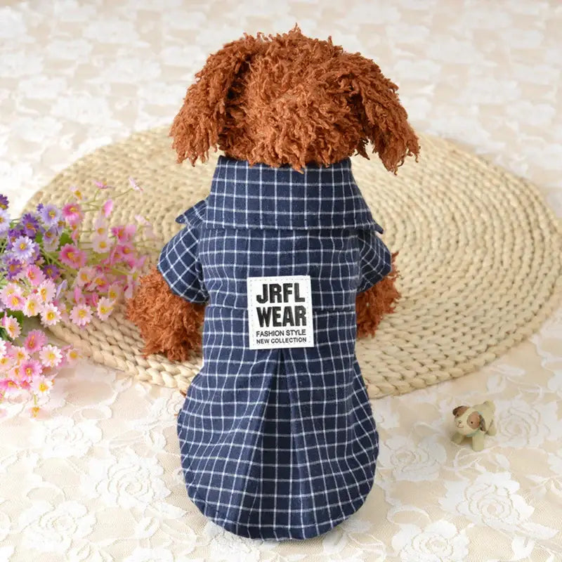 Stuffed toy dog wearing a blue plaid shirt with ’JRFL WEAR’ text.