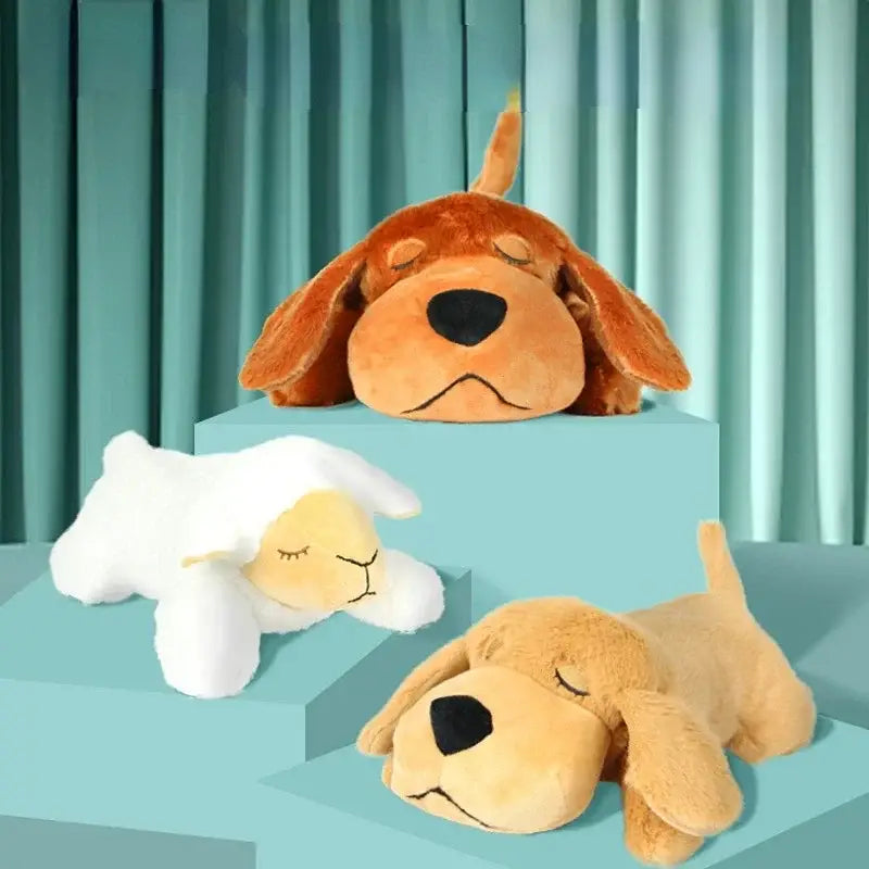 Plush toys of two dogs and a sheep with closed eyes.