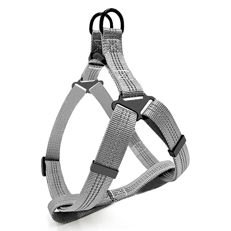 Dog harness made of gray fabric with adjustable straps and buckles.