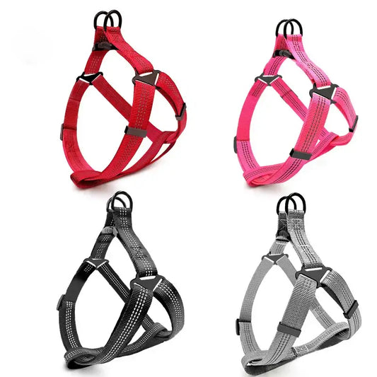 Dog harnesses in four different colors: red, pink, black, and gray.