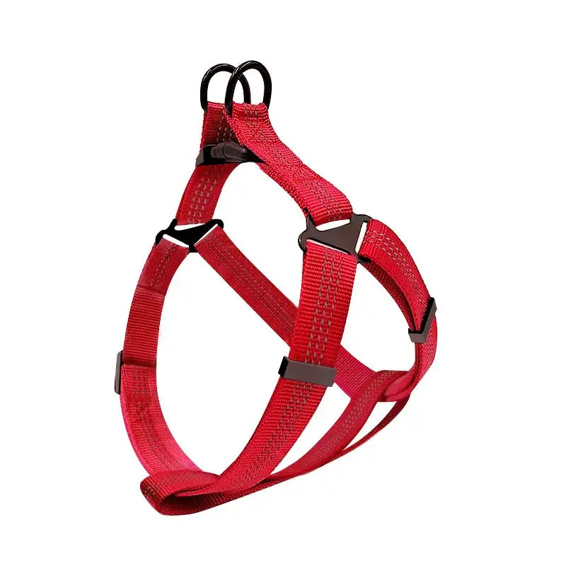 Red nylon dog harness with adjustable straps and black buckles.