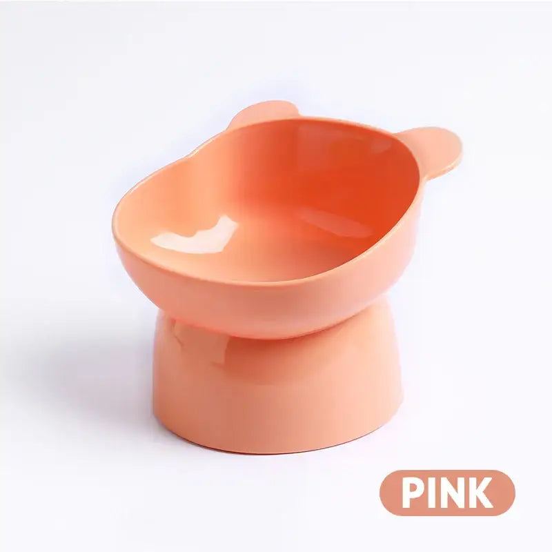 Elevated pink pet food bowl with curved edges and a wide opening.