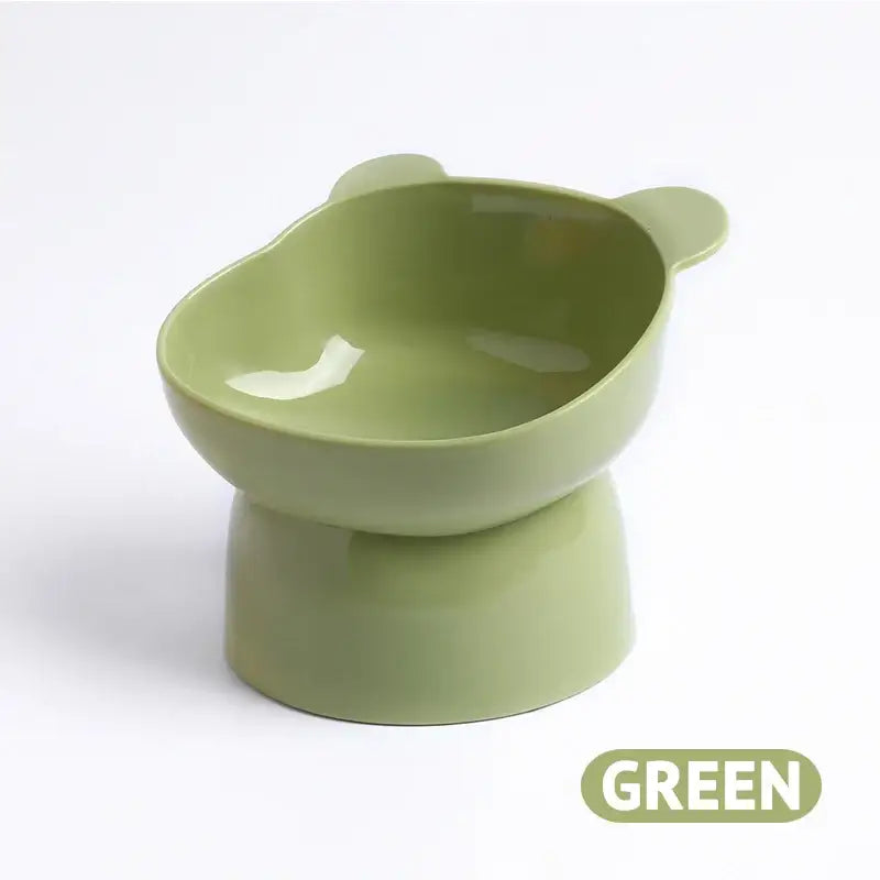 Light green elevated pet food bowl with ear-like protrusions.