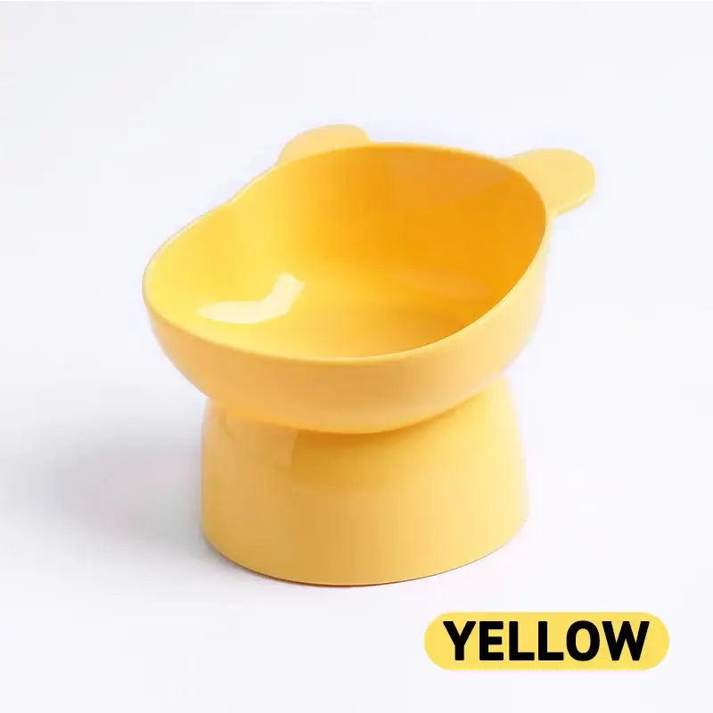 Yellow plastic elevated pet food bowl with ear-shaped sides.