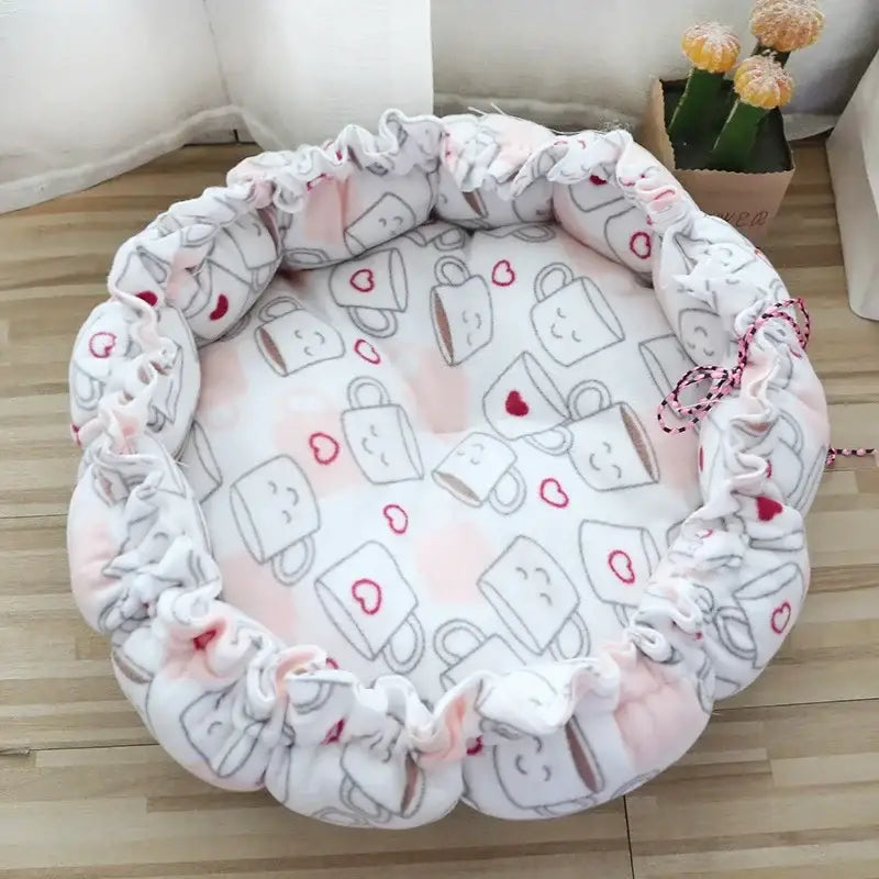 Circular pet bed with a cute milk carton pattern and ruffled edges.