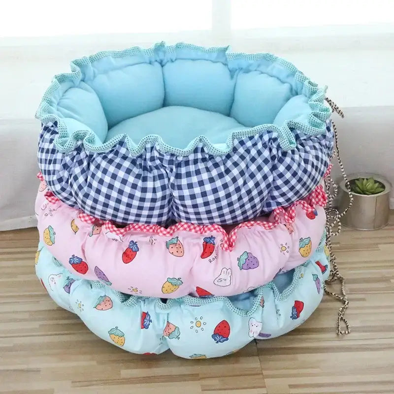 Colorful, layered pet bed with ruffled edges and various patterned fabrics.