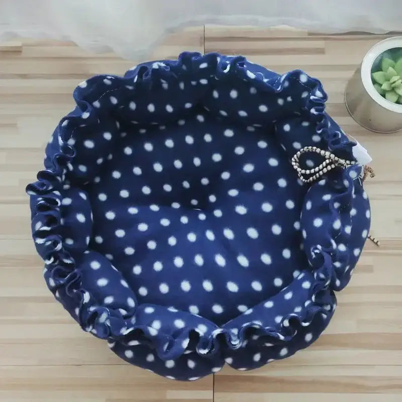 Navy blue polka dot fabric bowl with ruffled edges.