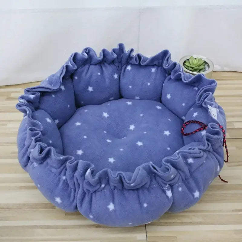 Plush, round pet bed with a ruffled edge in lavender fabric patterned with white stars.