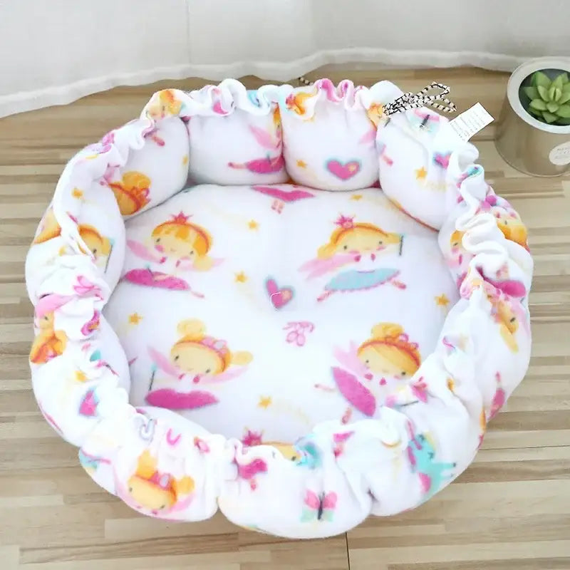 Soft, round pet bed with a colorful fairy or princess pattern.