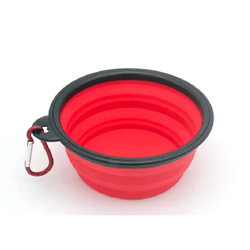 Collapsible red silicone pet bowl with a black rim and attached carabiner clip.