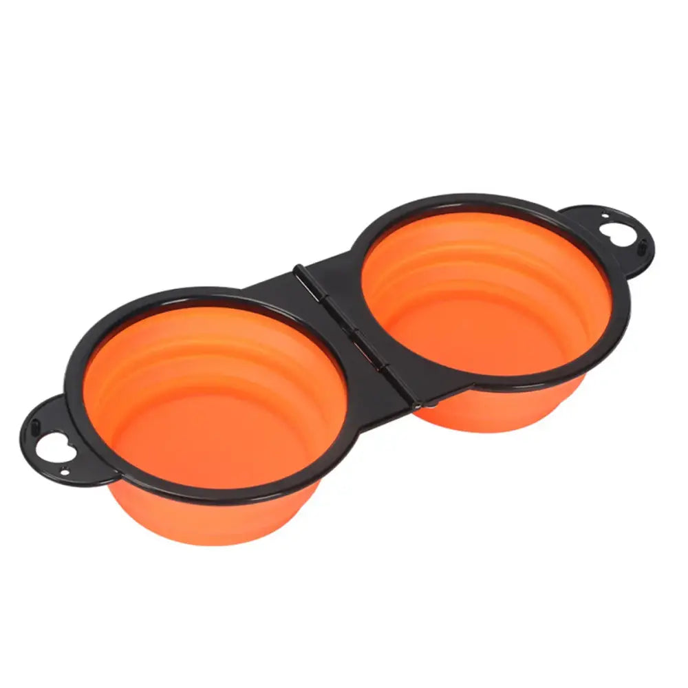 Collapsible orange silicone pet bowls connected by a black hinge.