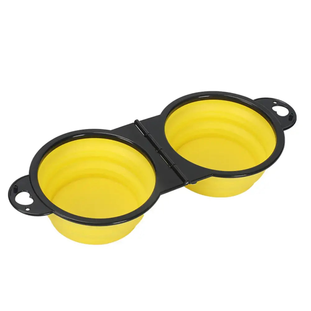 Collapsible yellow silicone bowls with black rims connected by a hinge.