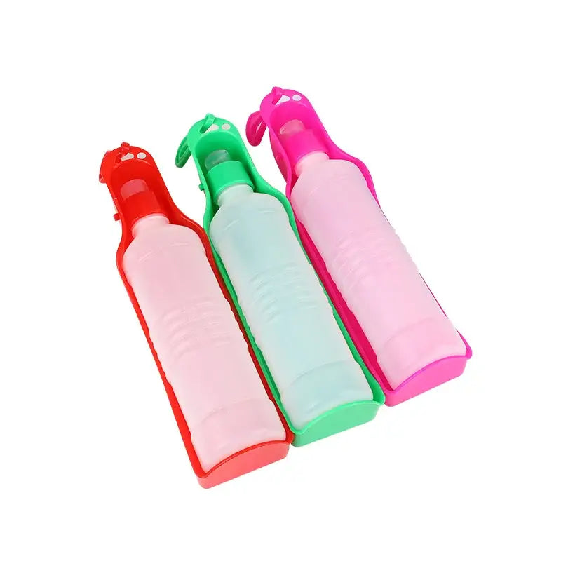 Three colorful plastic water bottles in red, green, and pink.