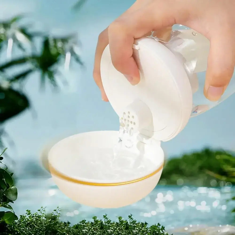 White ceramic bird-shaped salt or pepper shaker pouring its contents into a bowl.