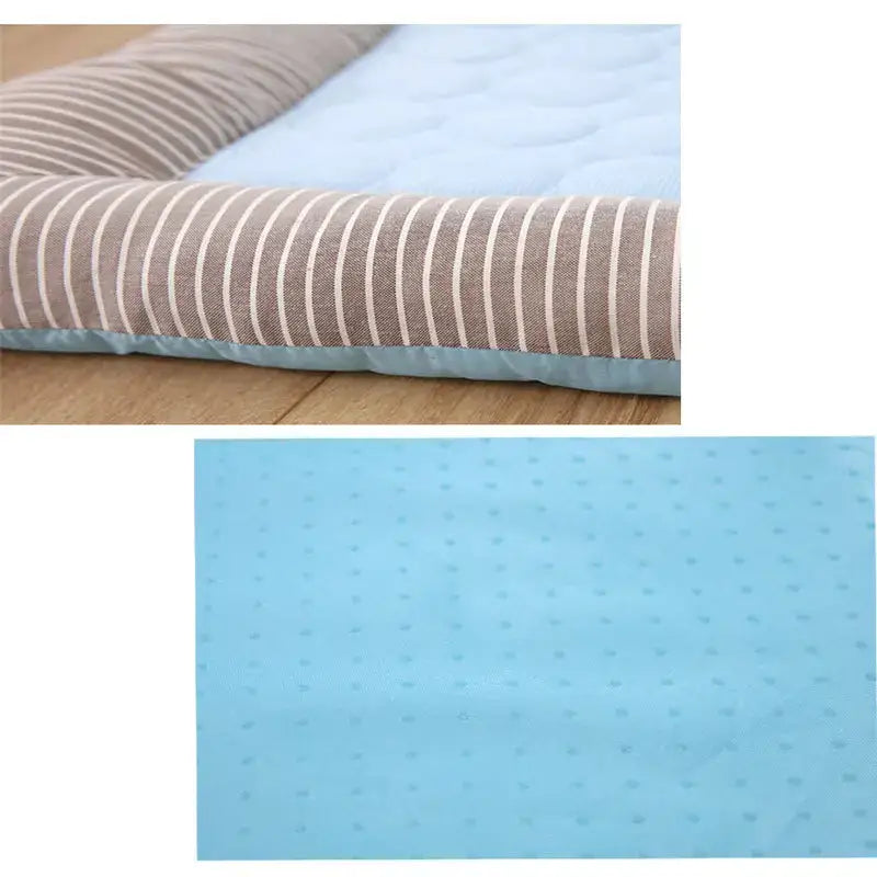 Memory foam mattress topper with a striped cover and blue underside.