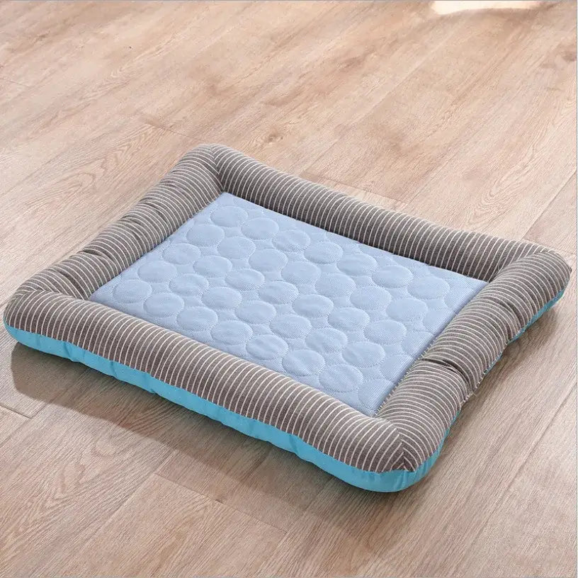 Pet bed with a quilted center and corduroy-textured border in gray and blue colors.