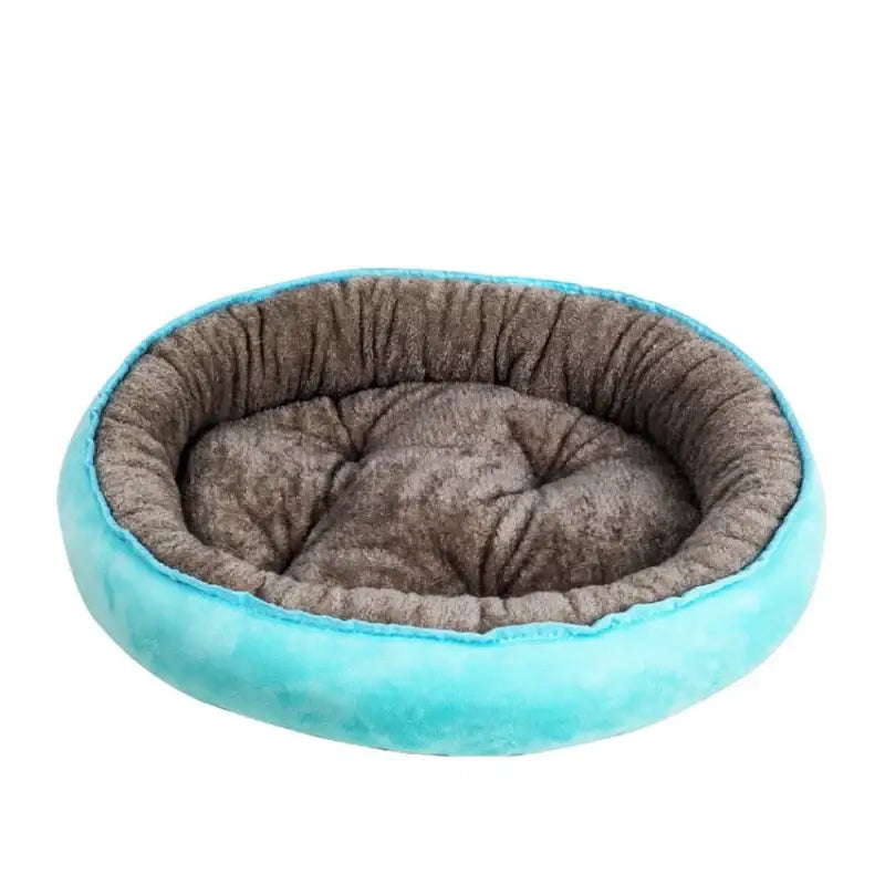 Circular pet bed with a teal outer rim and gray plush interior cushion.