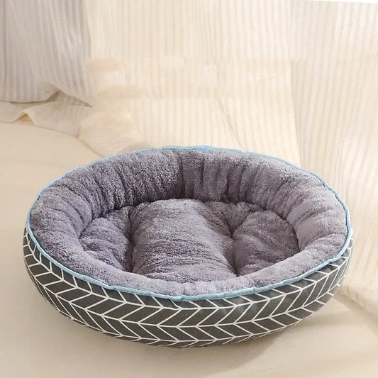 Round pet bed with a plush gray interior and patterned exterior.