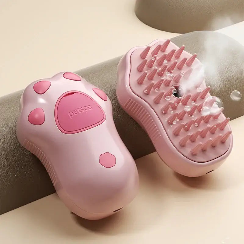 Pink handheld massager with a paw-shaped design and detachable spiked head.