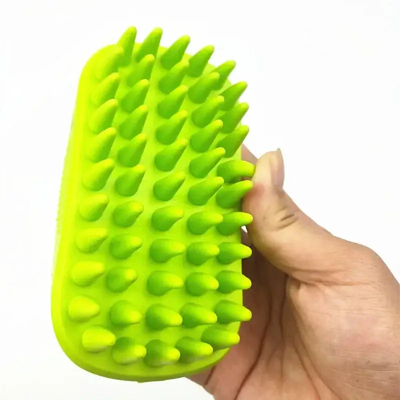 Bright green silicone brush or scrubber with numerous soft spikes held in a hand.