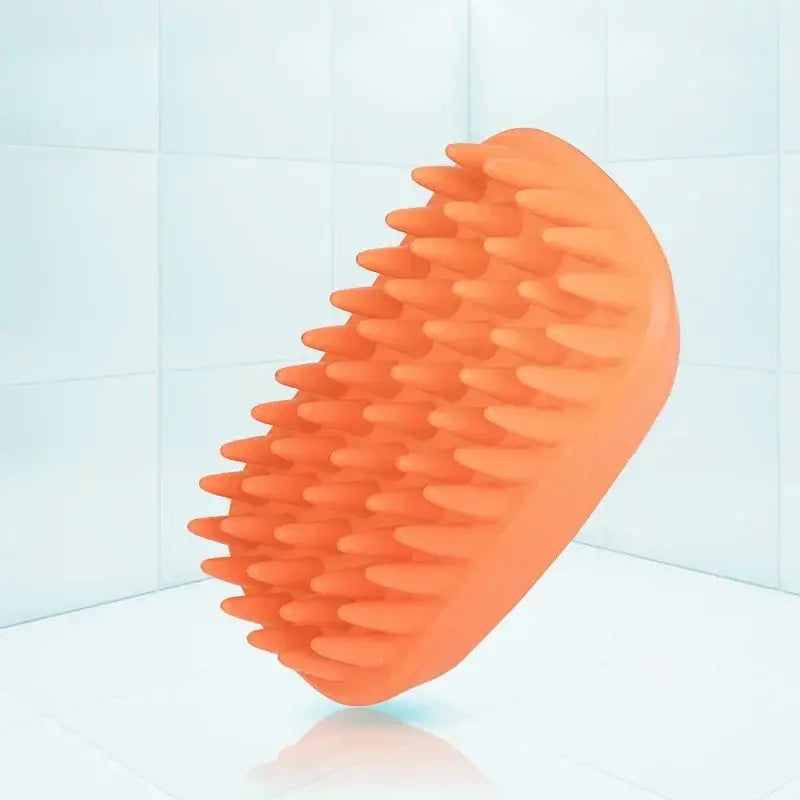 Orange silicone massage tool with multiple rounded protrusions.