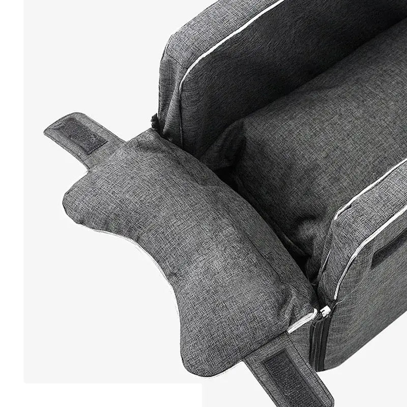 Gray upholstered armchair with a visible zipper and piping detail.