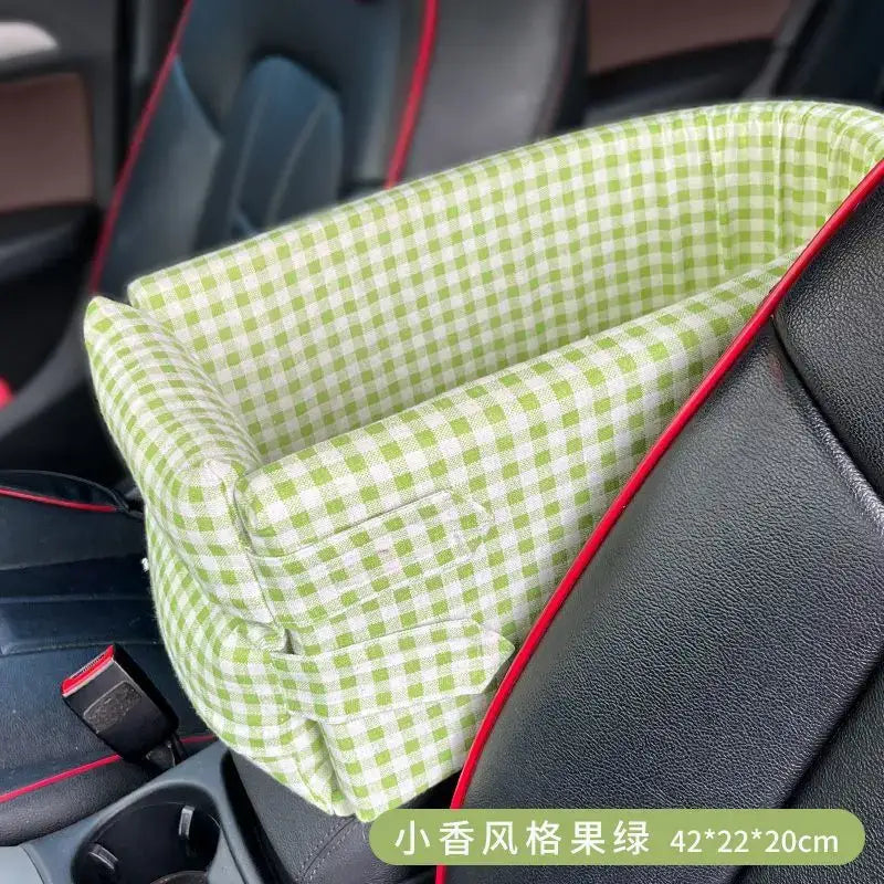 Green and white checkered fabric pet bed with red trim placed on a car seat.