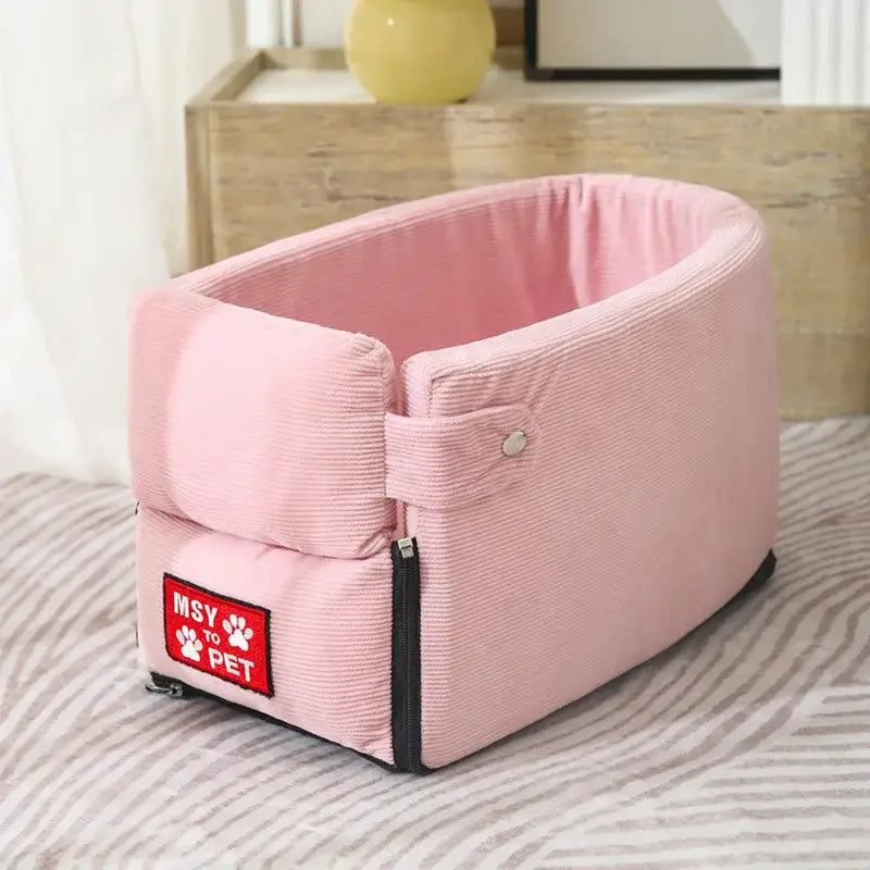 Pink corduroy pet bed with a red ’Hey Pet’ label attached.