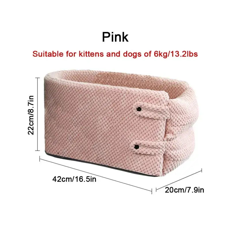 Pink padded pet bed with raised sides and a textured fabric surface.