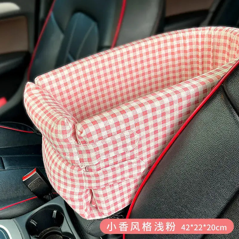 Pink and white gingham patterned pet bed or carrier designed to fit in a car seat.