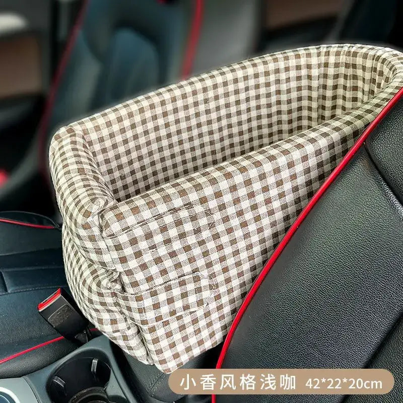 Plaid fabric pet bed with red trim designed to fit in a car’s center console or seat.