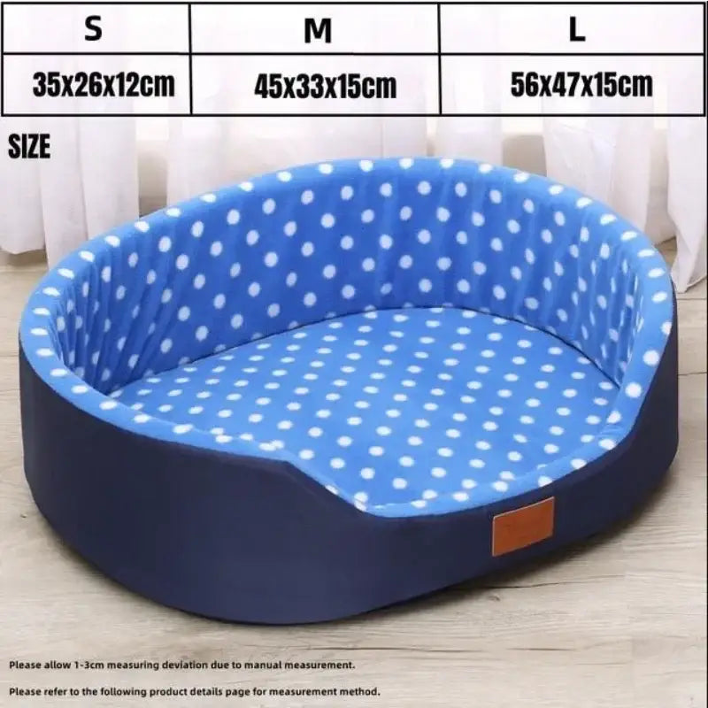 Blue polka-dot oval pet bed with navy exterior.