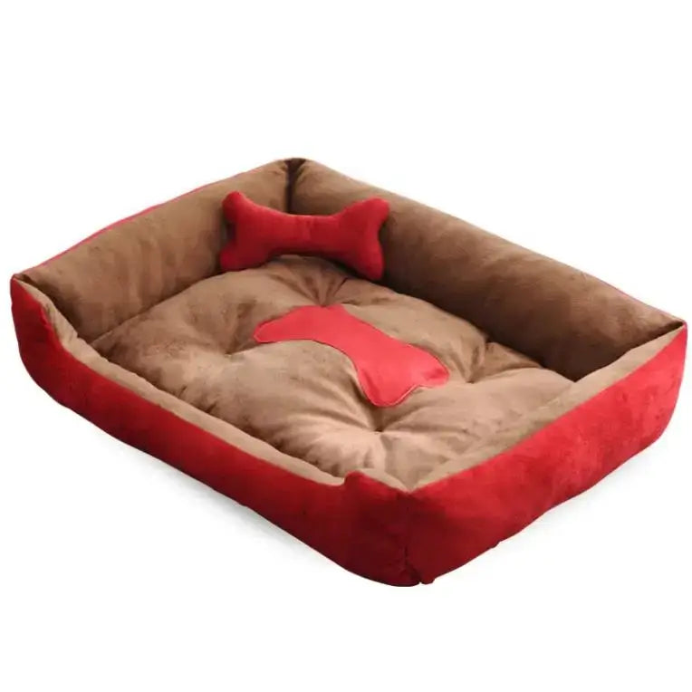 Plush rectangular dog bed with red trim and a bone-shaped pillow.